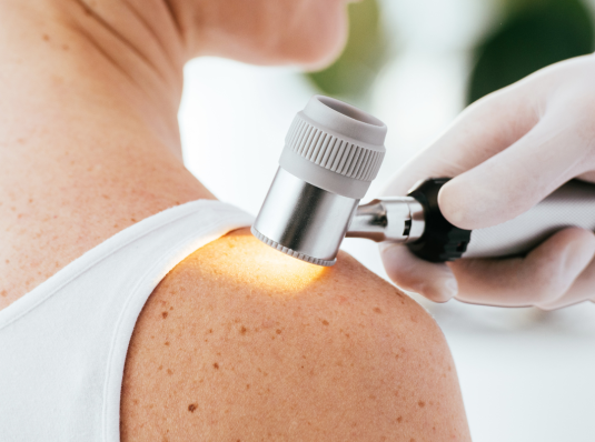 dermatologist examining a patient's skin